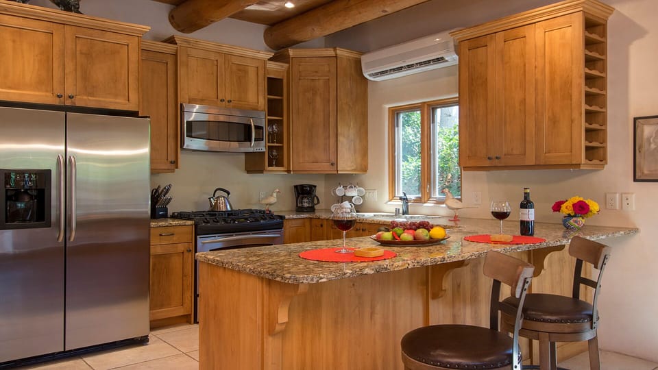 Fully equipped kitchen with stainless steel appliances and breakfast bar
