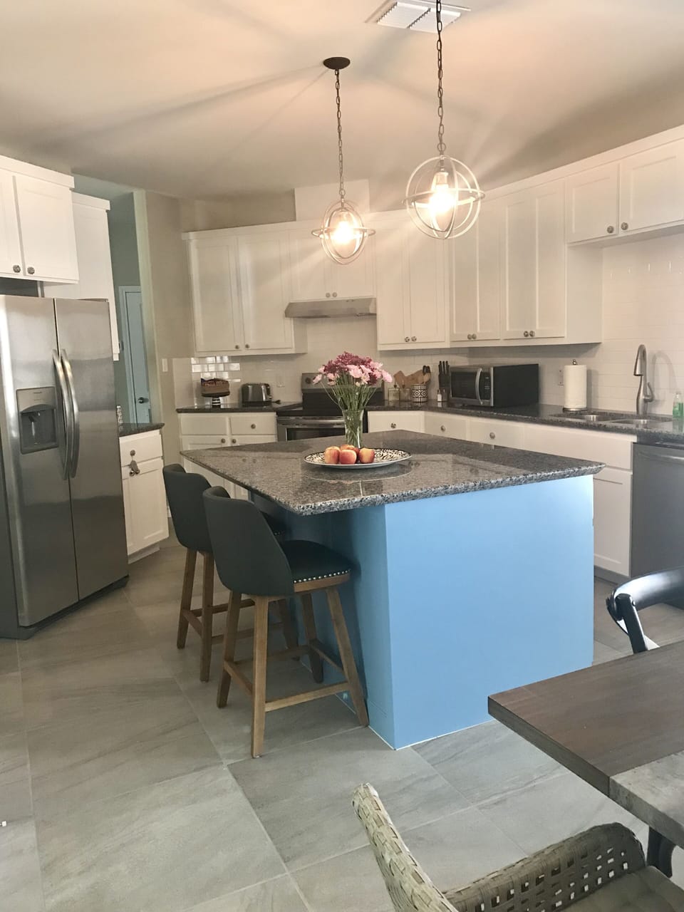 granite kitchen island with 2 barstools