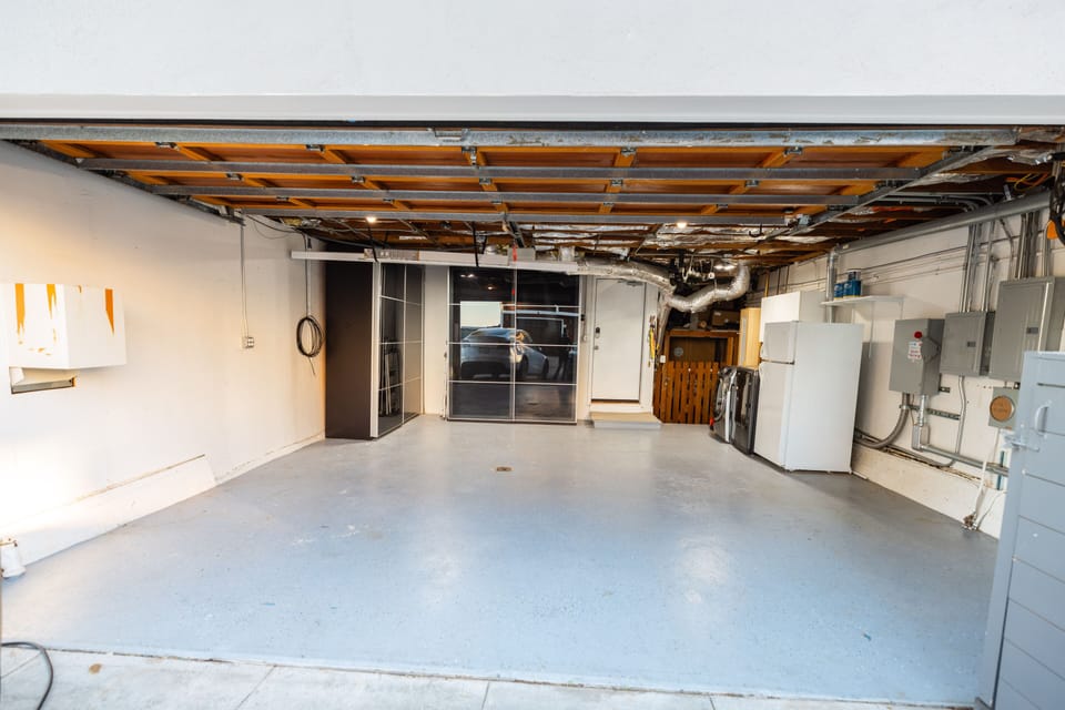 Garage with parking, storage, a wash-dryer, and an extra fridge, 240 EV charging