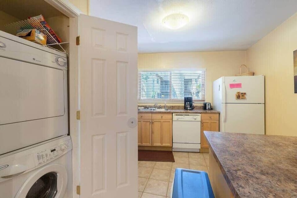 The in-unit laundry area is tucked into a closet off of the kitchen for your convenience and use.