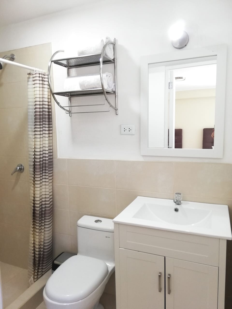Private Full Bathroom of Bedroom 1. Has towels, hair dryer, soap, and paper. 