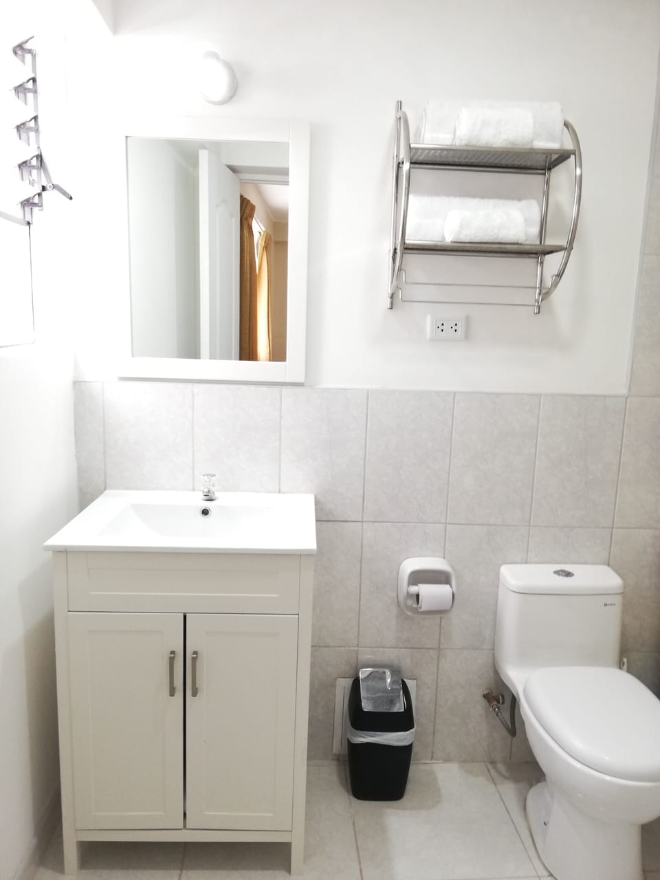 Private Full Bathroom of Bedroom 2. Has towels, hair dryer, soap, and paper. 