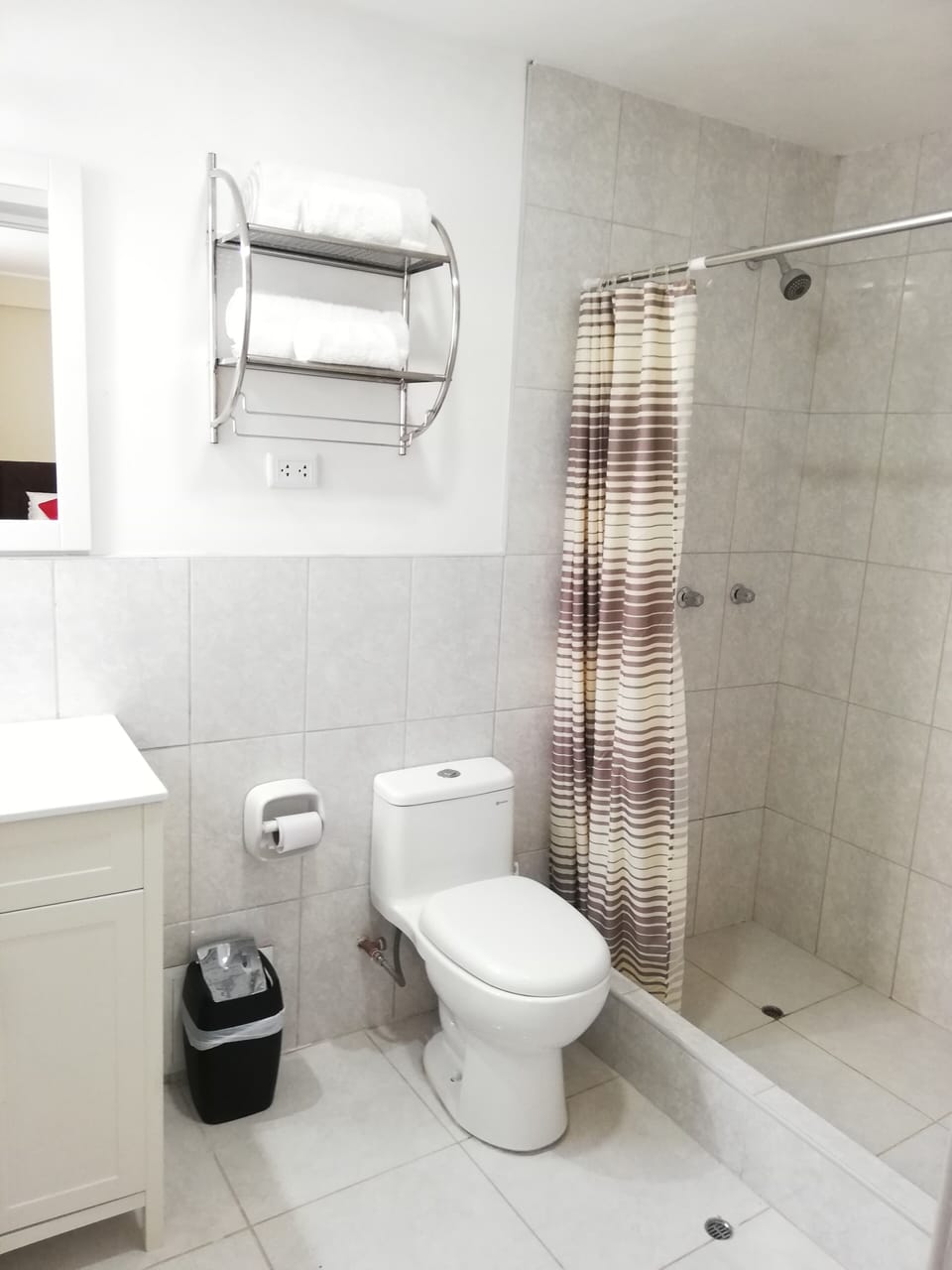 Private Full Bathroom of Bedroom 2. Has towels, hair dryer, soap, and paper. 