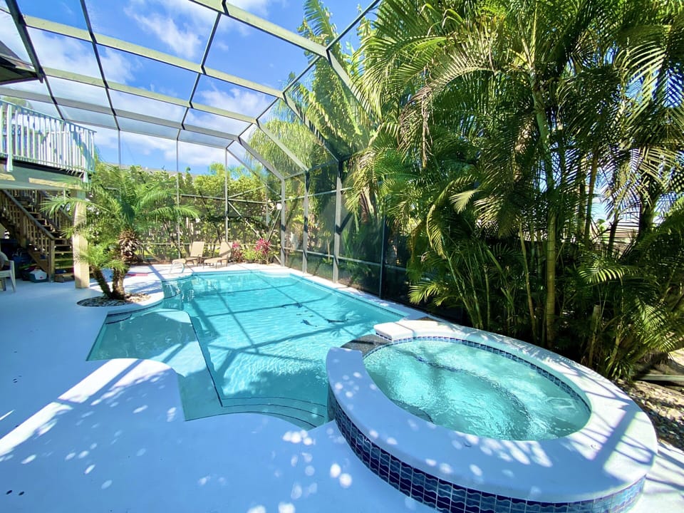 Florida living! Heated pool boasts a 2-story screen so no FL biting bugs!!