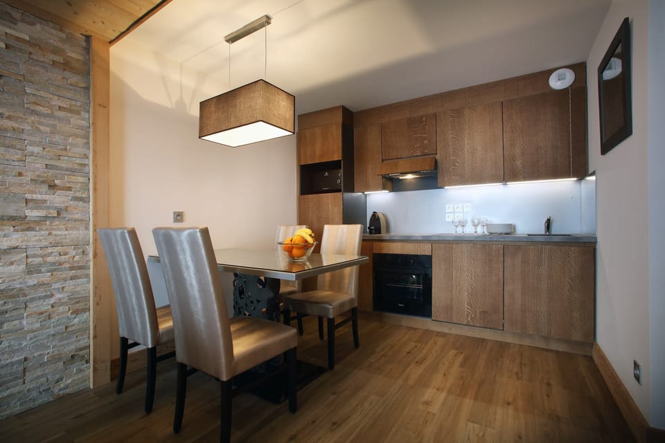 Prepare meals in the kitchenette and enjoy them at the dining table.