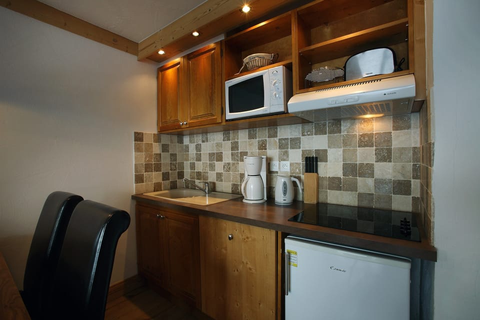 Prepare meals in the kitchenette and enjoy them at the dining table.