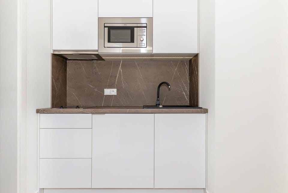 Kitchenette with microwave and electric kettle.