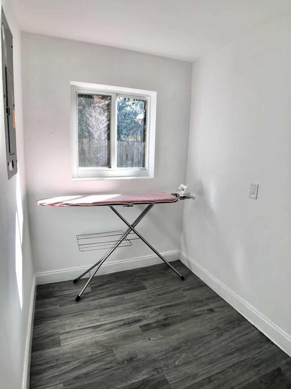 Laundry room with ironing area.