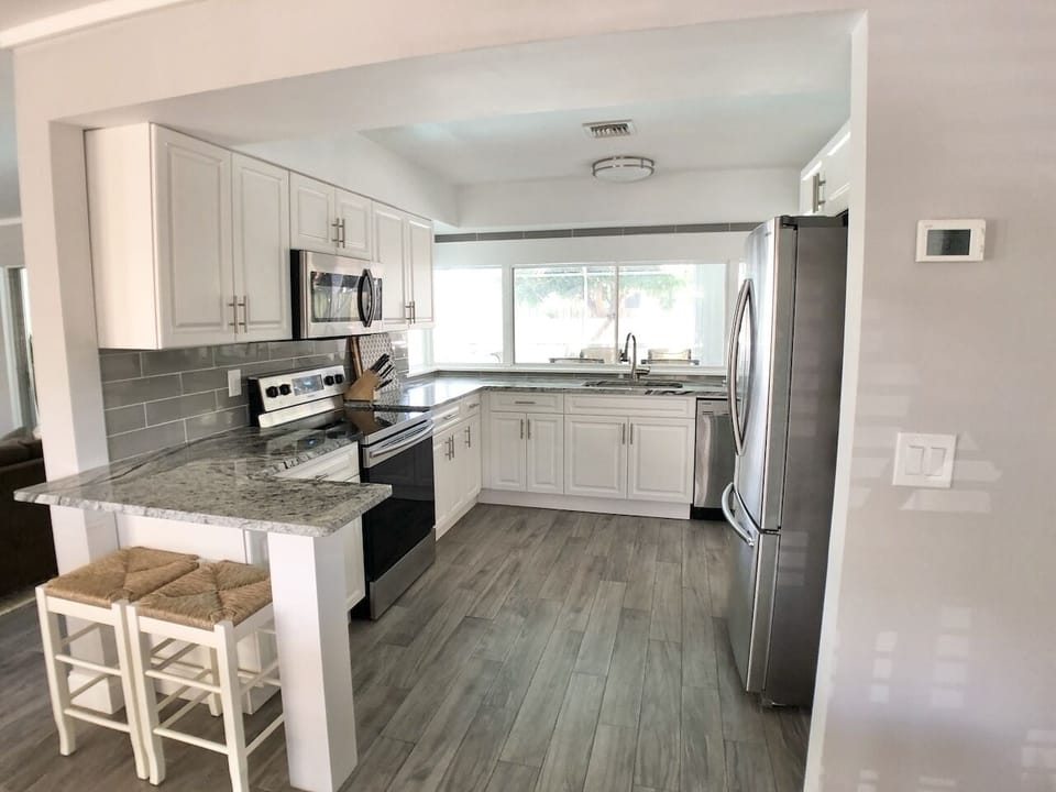 Modern open kitchen with newer stainless steel appliances.