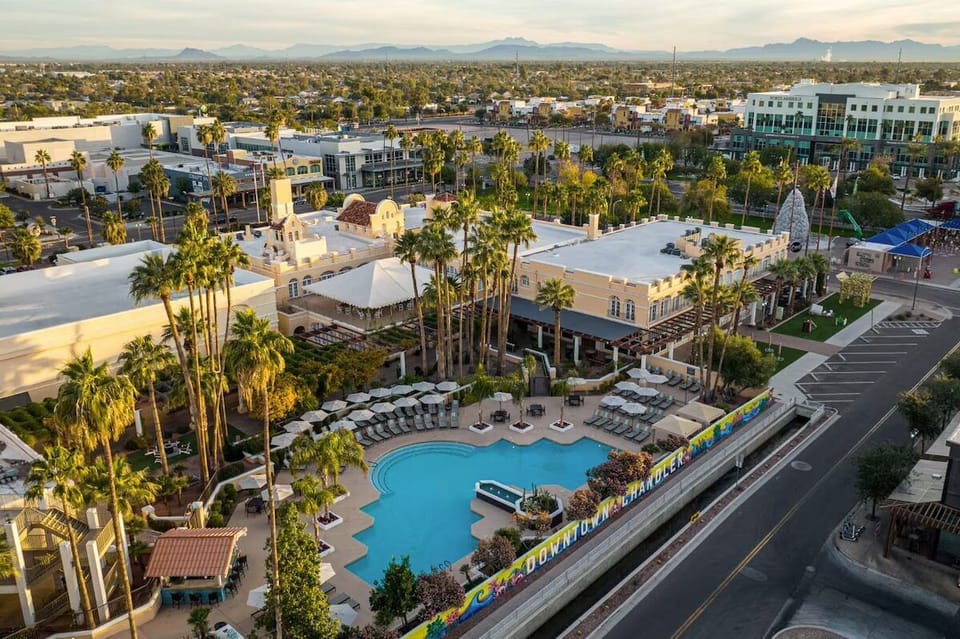 Soak up sunny resort vibes beside a sparkling palm-lined pool.
