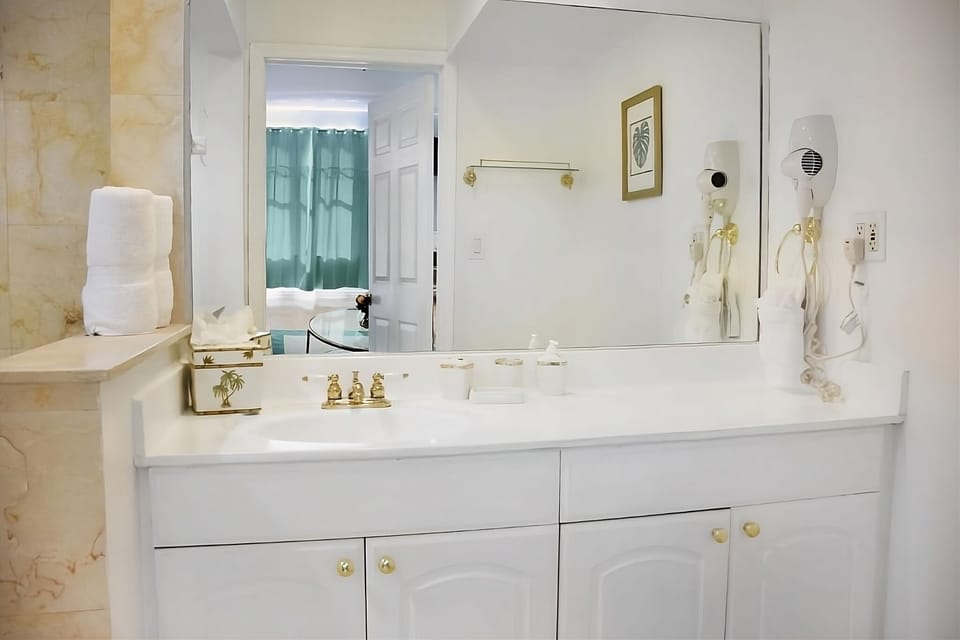 Refresh effortlessly with a bright vanity and generous mirror.