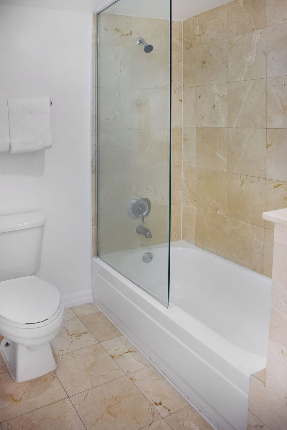 Rinse off in the glass-enclosed tub shower after a long day.