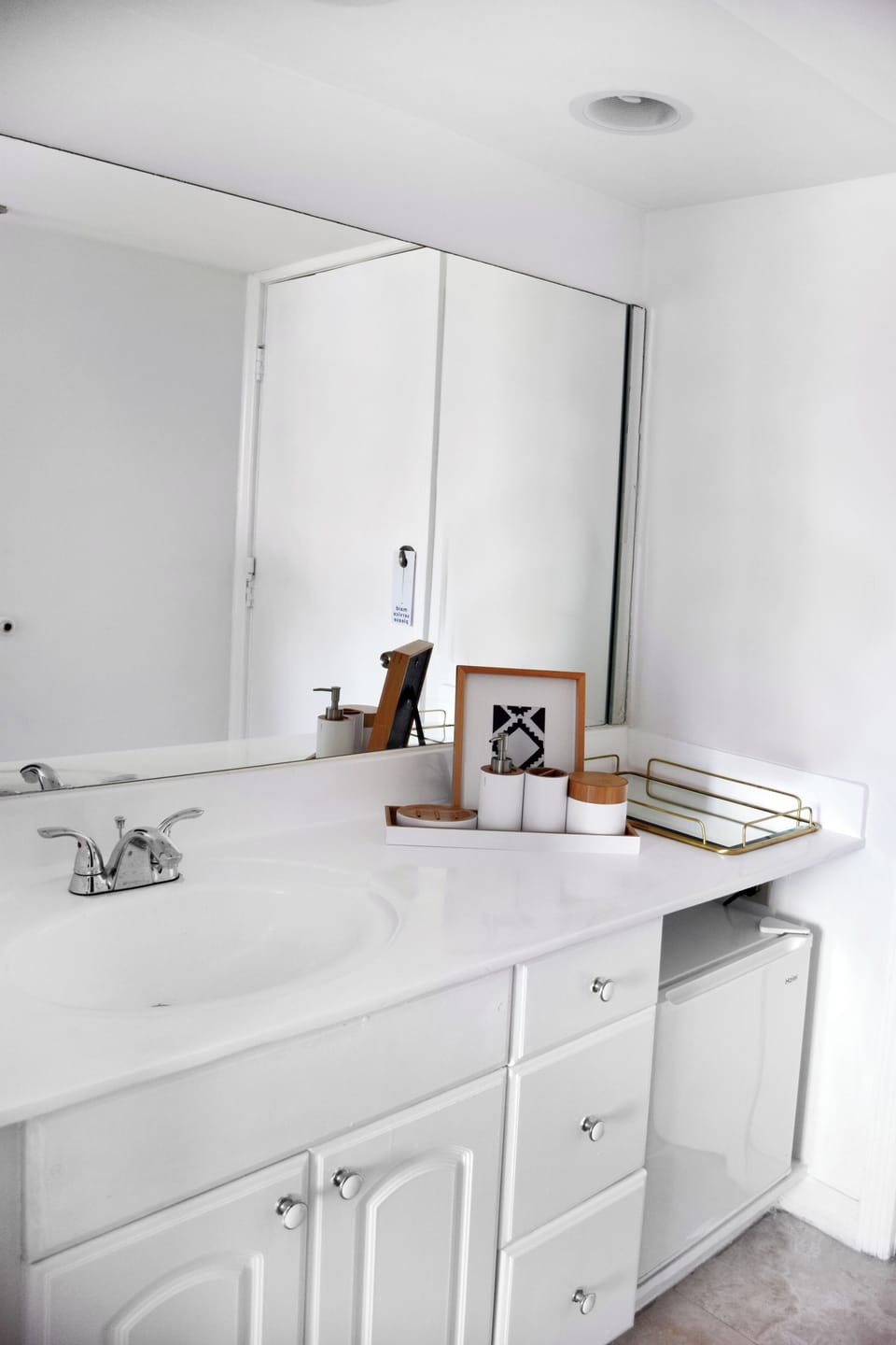 Refresh at the spacious vanity with bright, clean finishes.
