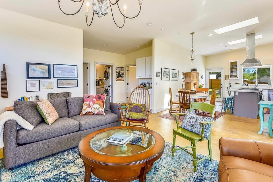 Comfy living room with sofa bed and cheery, eclectic decor.