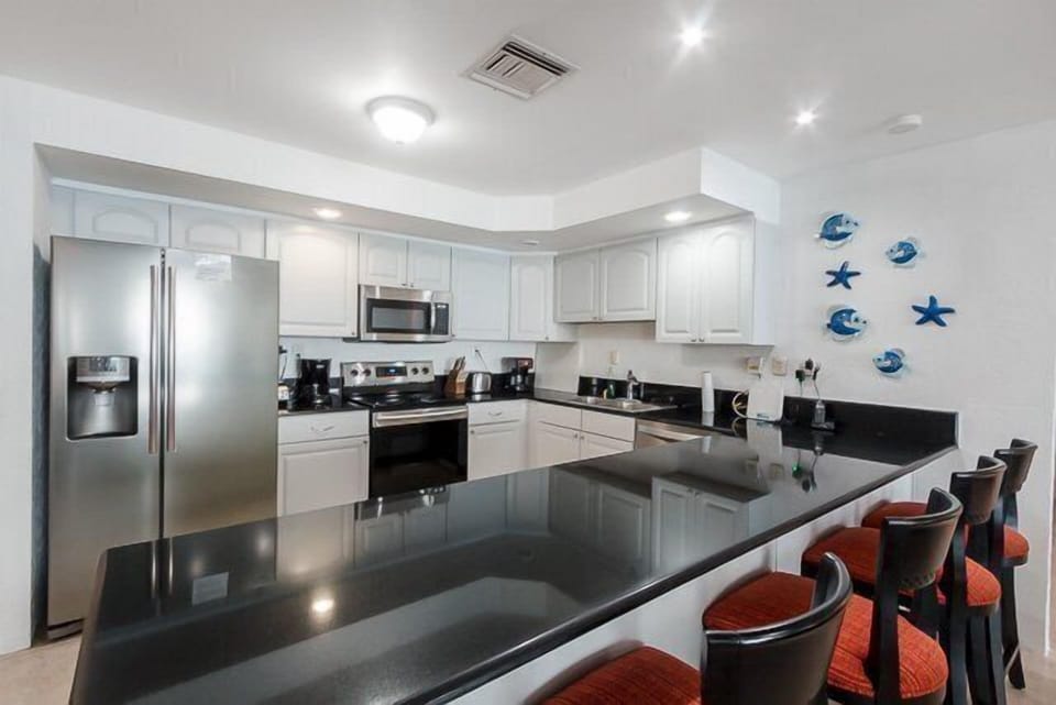 The kitchen has a breakfast bar and granite countertops.