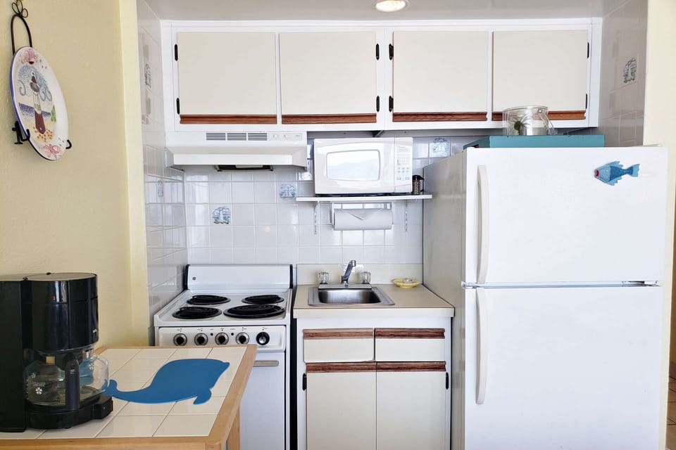 Kitchenette w/ full size refrigerator, 2 burner stove, mini oven, microwave, toaster oven, coffee maker, crock pot, cookware, plates & utensils.