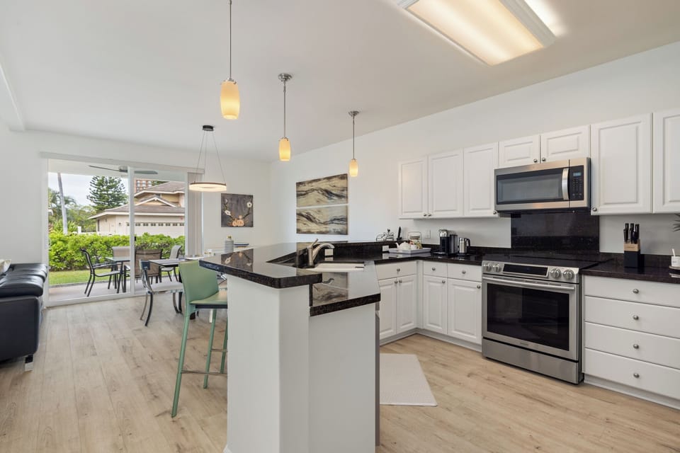 Kitchen viewed from hallway and dining area leading to ground floor lanai