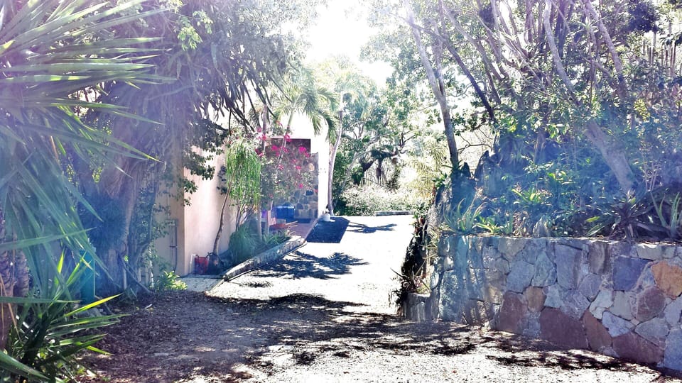 driveway to parking area and private studio entrance off south side of villa