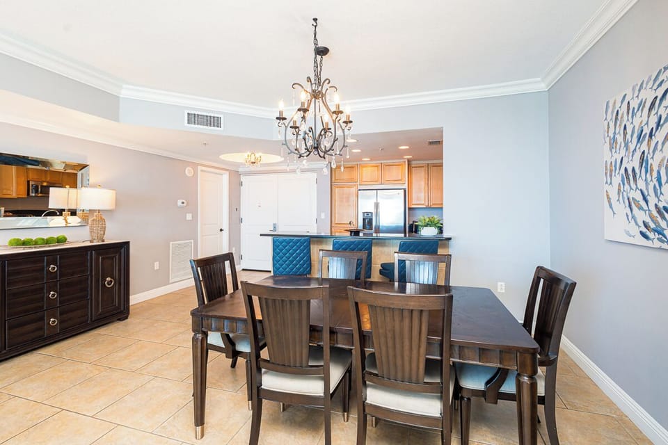 Picture yourself gathered here with loved ones, where an elegant chandelier sets the mood for memorable meals and the open-concept design lets conversations flow naturally from dining to kitchen.