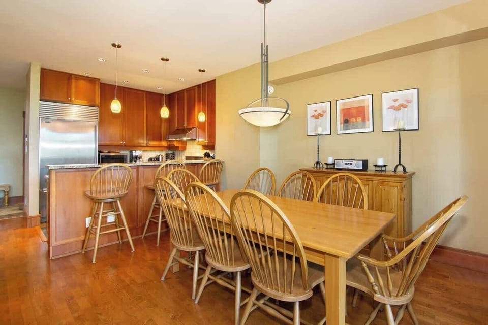 - Open dining area with a large wooden table perfect for group dinners  
- Bright space connected to kitchen with mountain-inspired decor  
- Ideal for sharing meals after exploring Whistler’s outdoor adventures  
