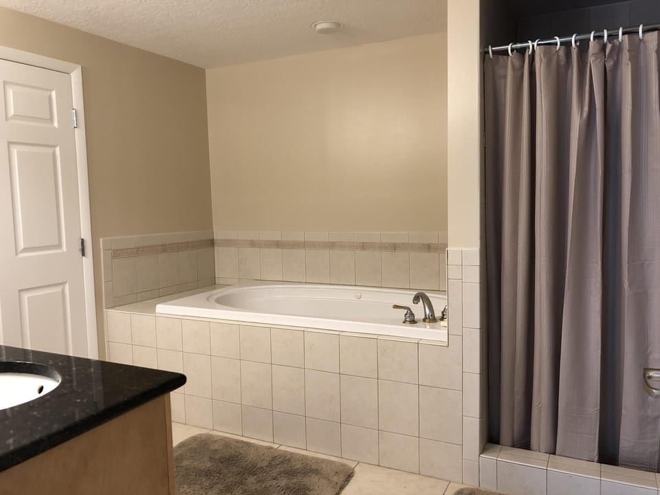 Master bath with jacuzzi tub, walk in shower, water closet and walk in closet.
