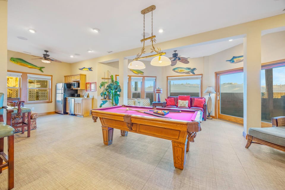 Challenge friends to a game on your full-size pool table, then unwind in the comfortable seating area with tropical charm.