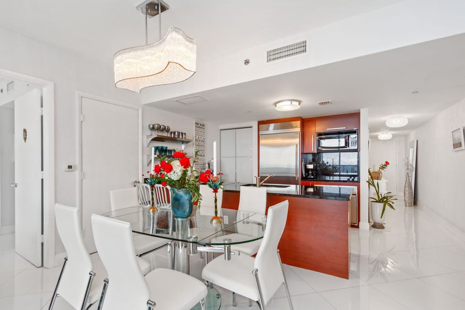 Comfortable leather chairs; glass table.  Chandelier has dimmer.
