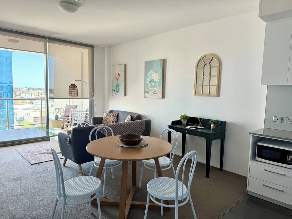 Enjoy meals and gather around the stylish 4-seater dining table, perfectly integrated into this bright, open-plan living space with balcony access.