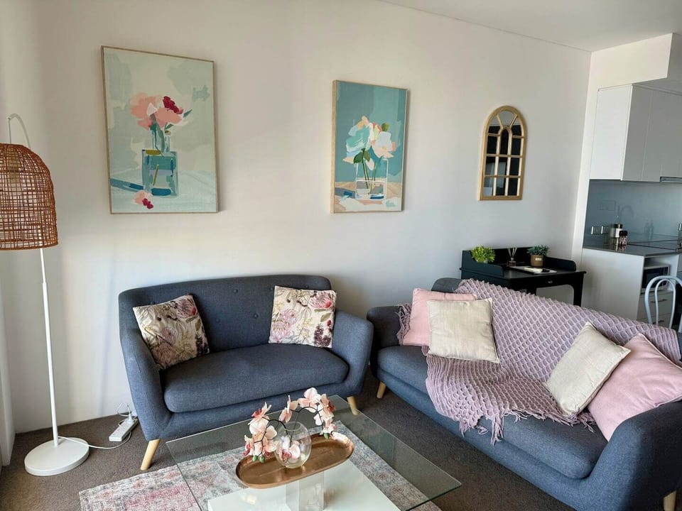 Relax in this beautifully styled living area, featuring comfortable sofas, charming artwork, and a cozy ambiance for unwinding after your adventures.
