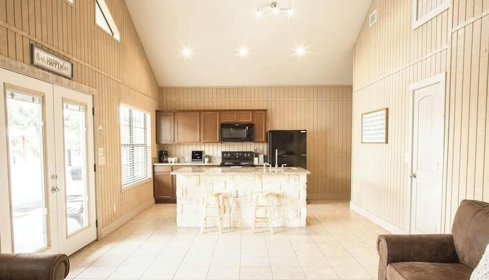 Kitchen. There is a picnic table for dining in this house. 