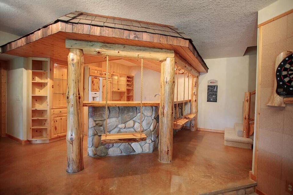 Downstairs bar with refrigerator, microwave and sink