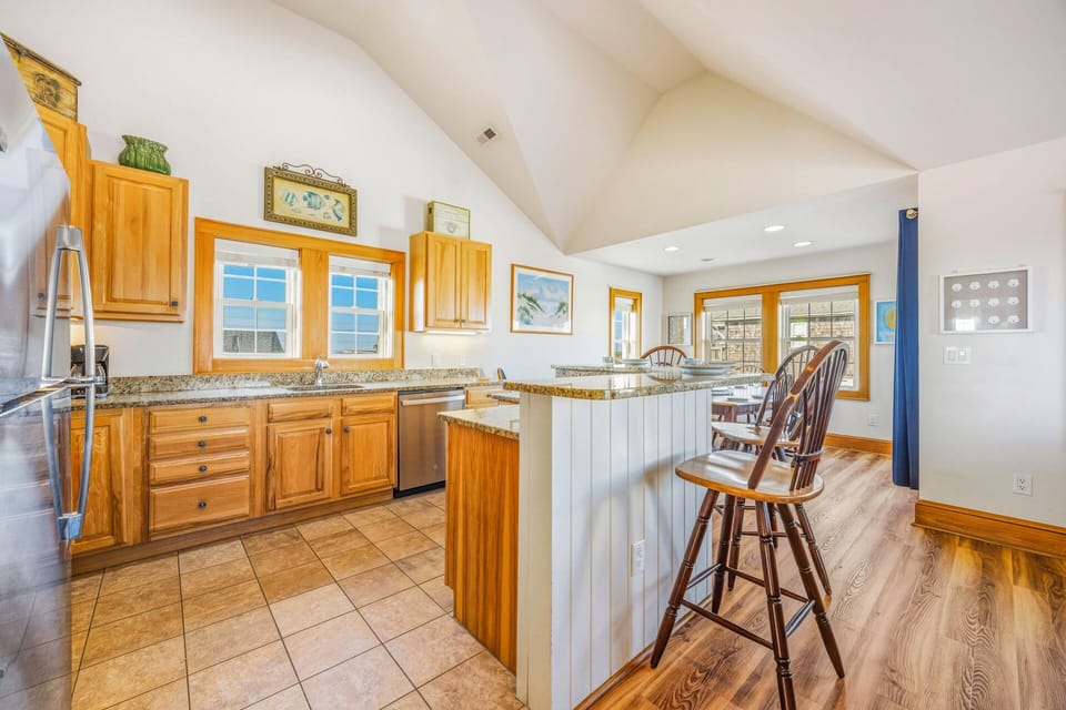 Your spacious kitchen features warm wood cabinets, granite countertops, and a welcoming breakfast bar where you'll love sharing morning coffee together.