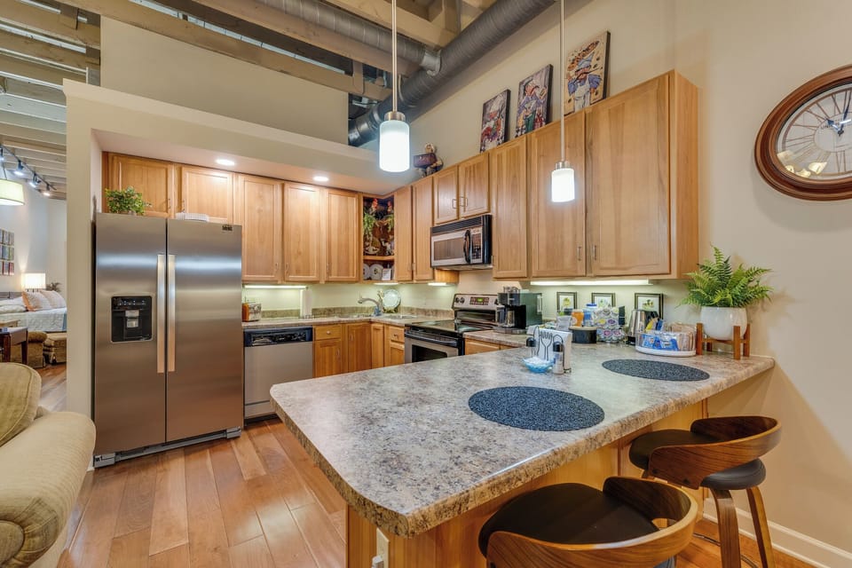 This eat-in kitchen counter is a perfect place to enjoy a meal. And you can make time to kick back and watch a movie on this HD TV. 