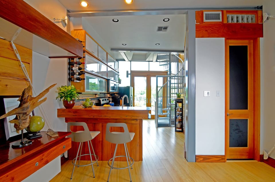 2nd Floor | Living/kitchen area and dining counter. Half bath on right-side.