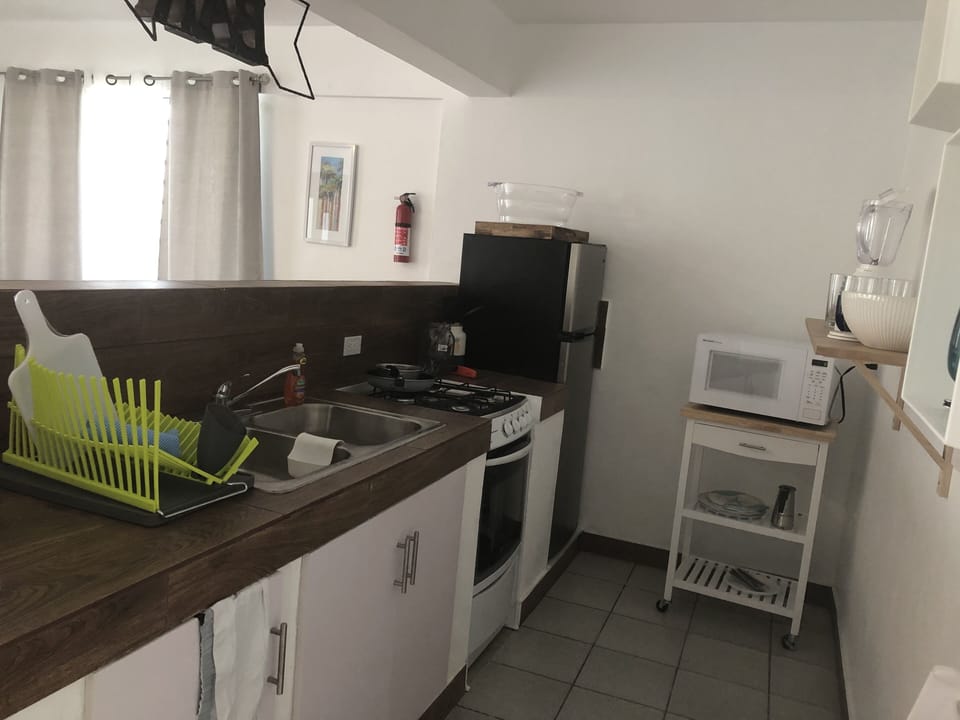 Kitchen with refrigerator, stove, and microwave.