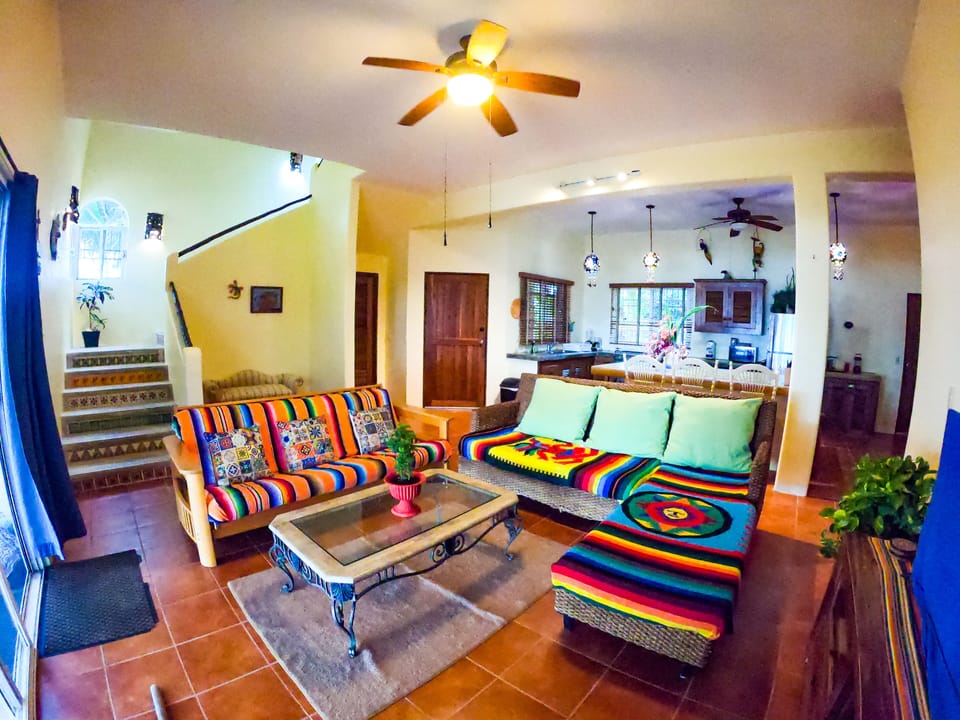 Open concept living room and kitchen with sliding doors to the oceanfront patio