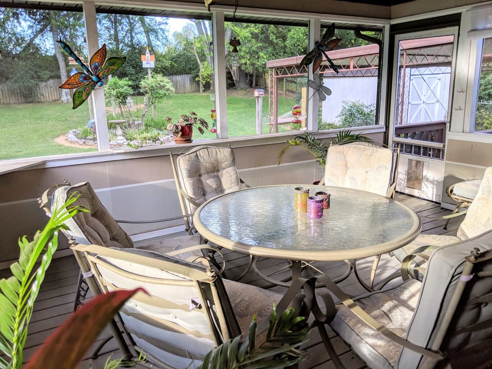 Screened-in Patio overlooking large fenced Backyard