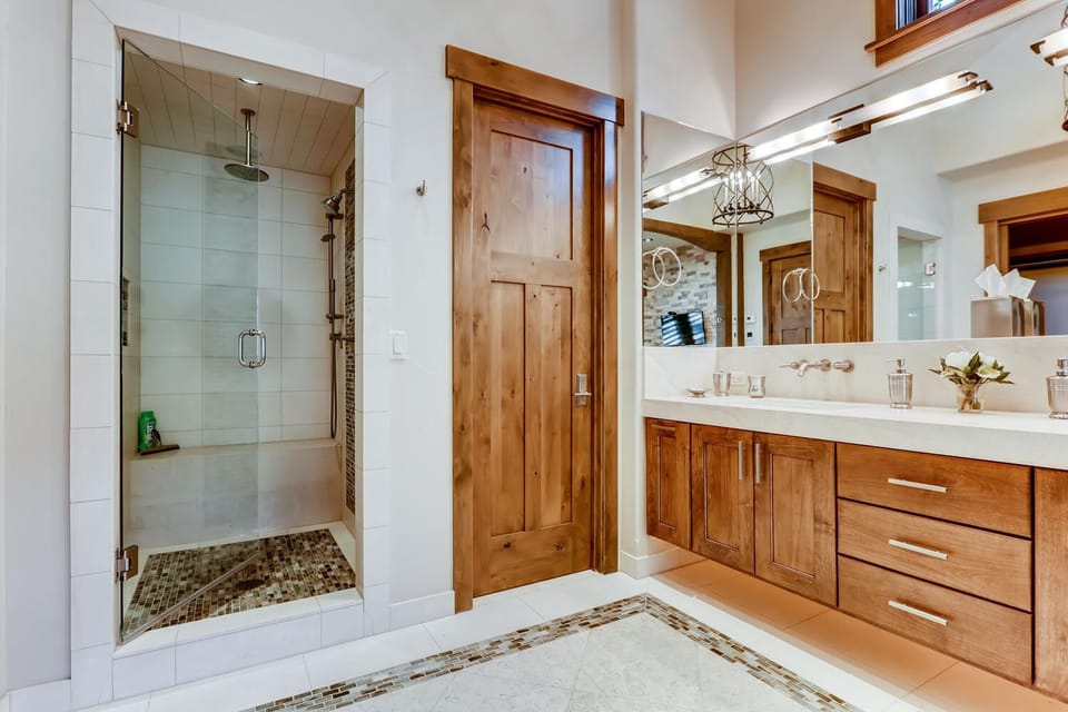 Ground floor primary bathroom featuring a separate walk-in shower, walk-in closet, and private toilet room.