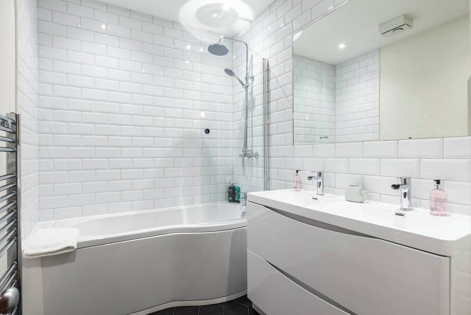 Newly refurbished bathroom, with power shower above the bath.