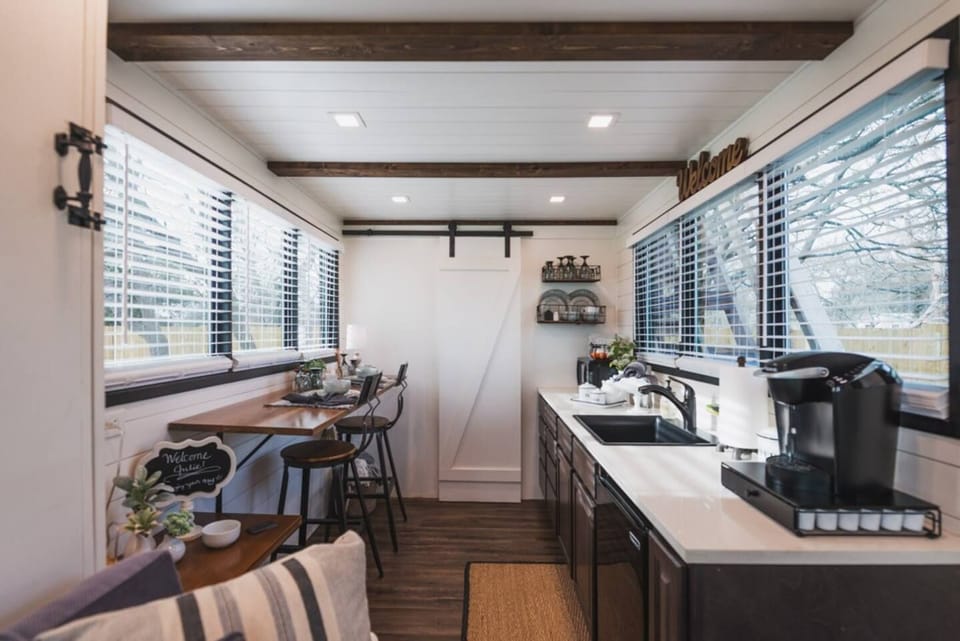 Kitchen and dining areas framed by huge picture windows.