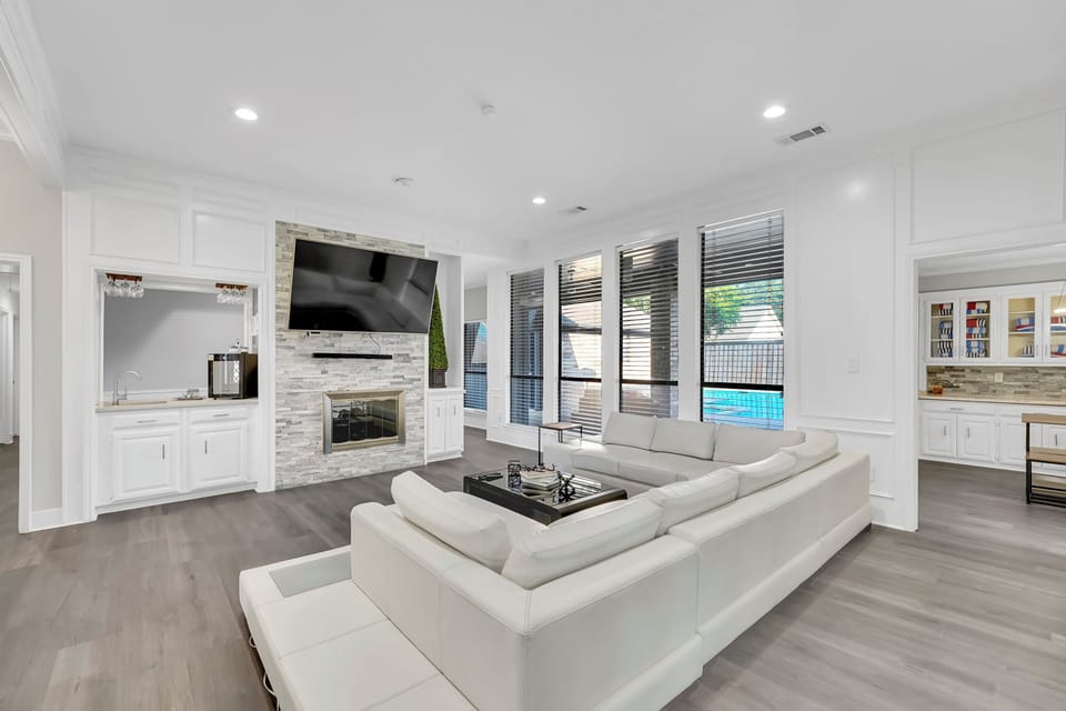Living room with large 80 inch smart tv and sound bar