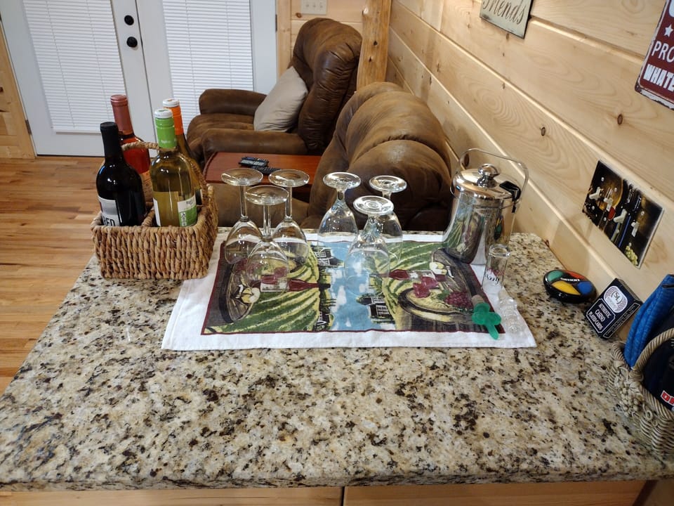 Bar area with wine glasses to enjoy ONE complimentary bottle of wine on us!