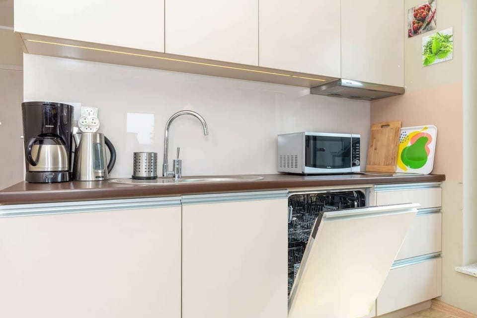 Kitchenette with dishwasher and refrigerator. 