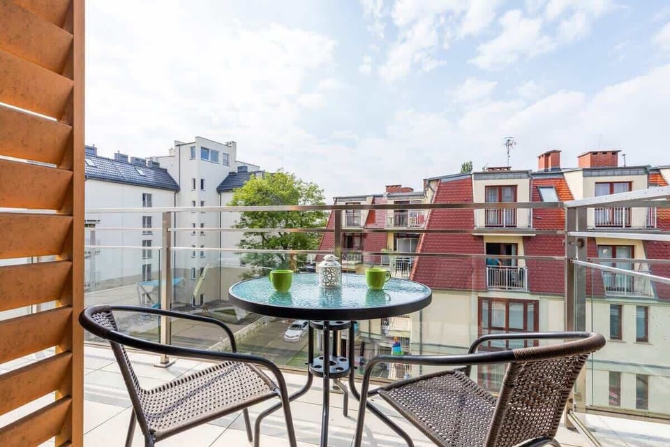 Spacious balcony with outdoor furniture. 