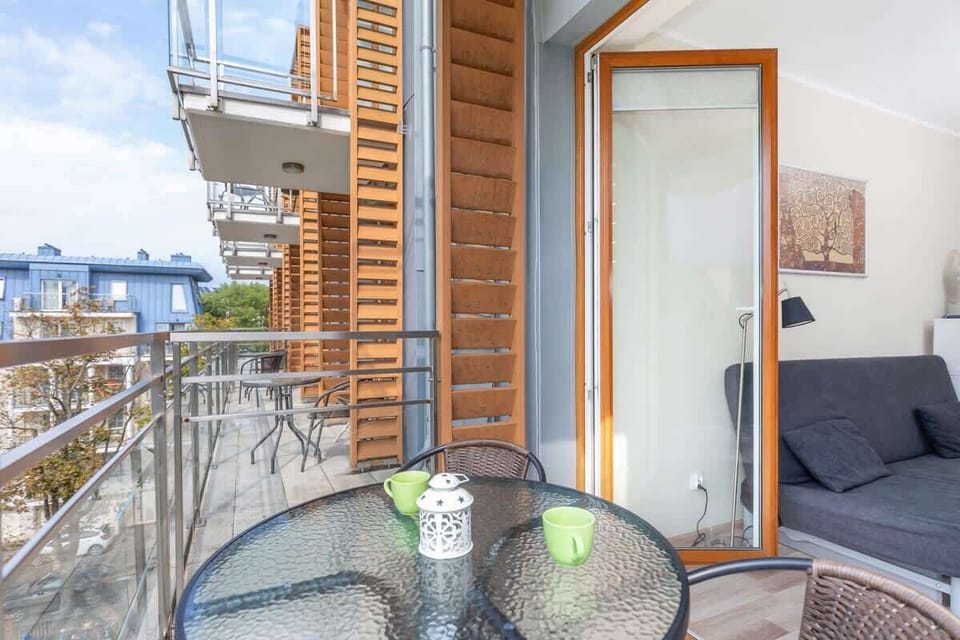 Spacious balcony with outdoor furniture. 