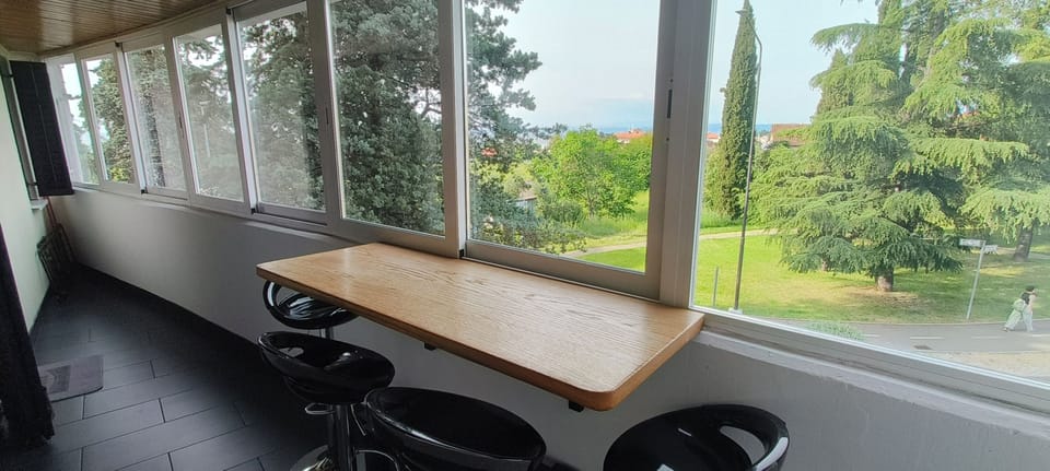 Balcony with bar table and bar stools