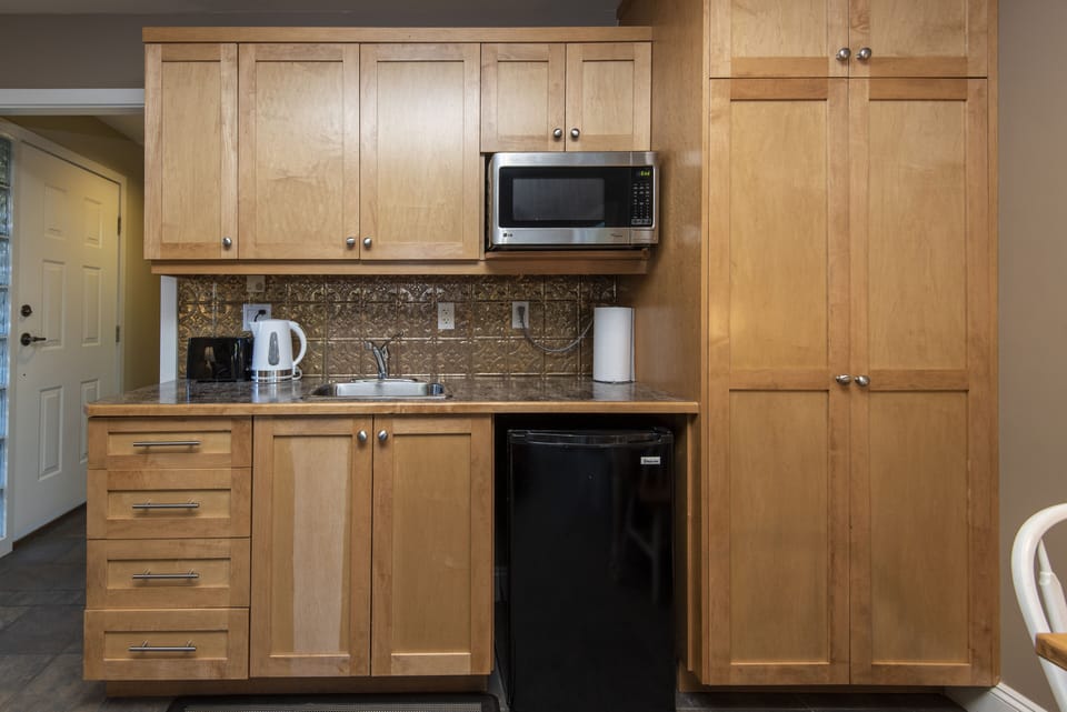 Chic copper black splash with a variety of appliances  