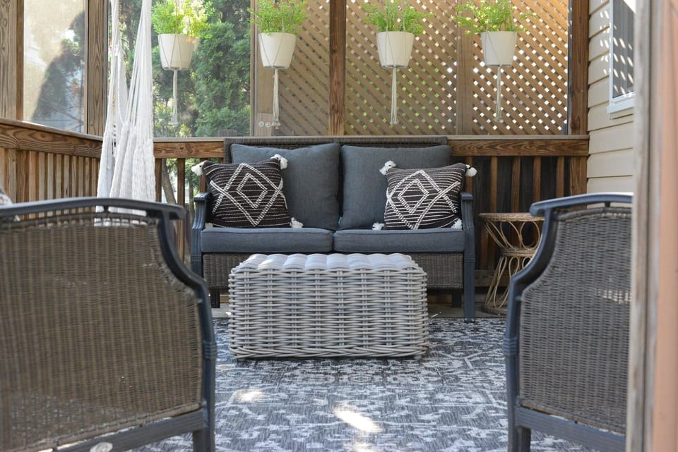 Door in kitchen leads to a comfortable screened-in outdoor space.