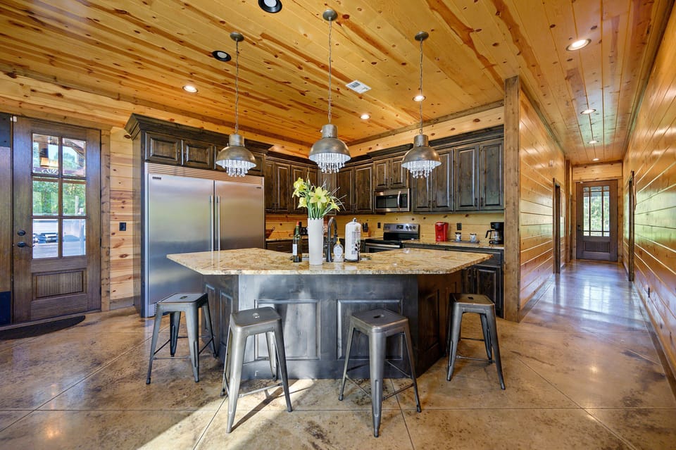 The fully equipped chef’s kitchen features stainless steel appliances, a commercial-size refrigerator, and plenty of space to cook for the whole crew.