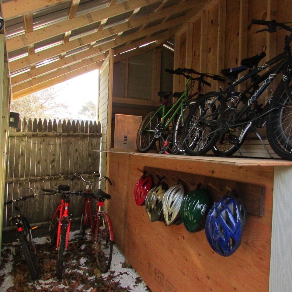 Bikes, helmets, and kayaks in the shed.